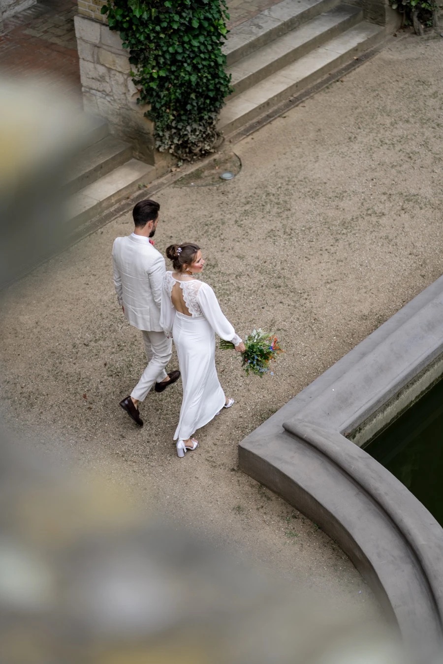 Wedding couple sharing a quiet moment in a courtyard