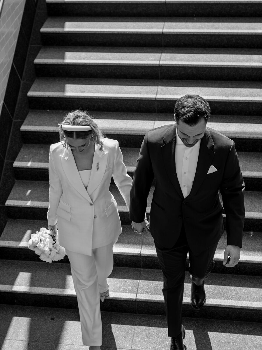 Bird's-eye view of a wedding couple crossing a courtyard